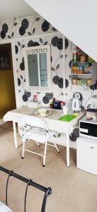 a white desk with a mirror on a wall at House on the Corner B&B in Didcot