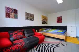 a living room with a couch and a bed at Apartman Veronika in Trojanovice