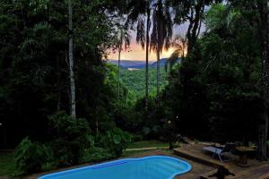 a blue swimming pool in the middle of a forest at Chacra del Agua Reserva Privada in Moconá Falls