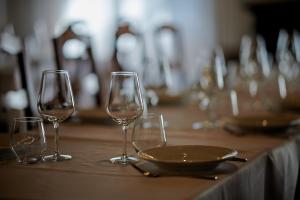three wine glasses and a plate on a table at Hotel Villa Ciconia in Orvieto +41 photos