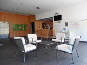 a meeting room with chairs and a table and a chalkboard at HI Melgaco - Pousada de Juventude in Melgaço