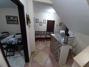 a hallway with a table and chairs in a room at Pousada Pena in Aparecida