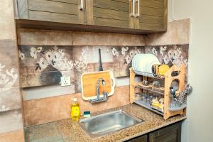 a kitchen counter with a sink and a mixer at Two Bedroom Deluxe Apartment In Bahria Town in Rawalpindi