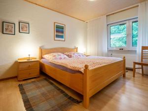 a bedroom with a wooden bed and a window at Holiday home in Kyllburg Eifel near the forest in Kyllburg