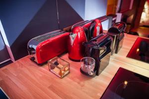 a counter top with a red toaster and a glass at L'Espace Privé 2 Rouen in Rouen