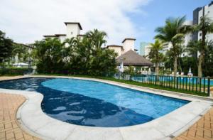 una piscina en un complejo con palmeras en Riviera São Lourenço, cond Acqua! 30 seg da praia - lindo apto com wifi e ar condicionado en Riviera de São Lourenço