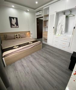 a bedroom with a bed and a closet at Khánh Phong Apartment in Waterfront in Hai Phong