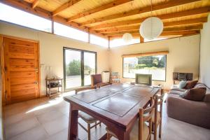 a living room with a wooden table and a couch at Casa Barrio Acantilados proxima al mar in Mar del Plata