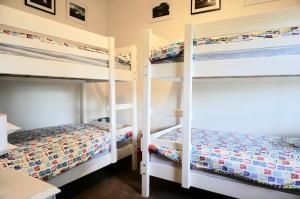 two bunk beds in a room with a bed at Bluey's in Queenscliff