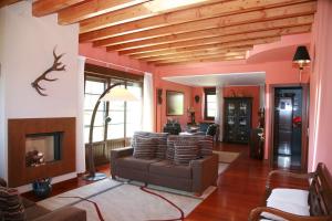 a living room with a couch and a fireplace at Casa Rural Telleri in Sopelana