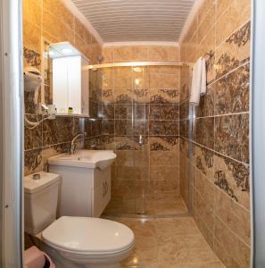 a bathroom with a toilet and a sink and a shower at Avrupa Palace Hotel in Avcılar +32 photos