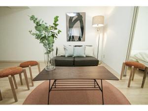 a living room with a table and a couch at SAPPORO HILLS in Sapporo