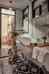 a bathroom with a bath tub in a room at The Knight House Bangkok in Bangkok