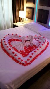 a heart made out of red hearts on a bed at Vatican Relais Rome in Rome