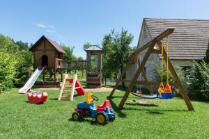 a playground with various toys in the grass at Gasthof-Pension Brauner Hirsch in Alfeld - Mittelfranken in Alfeld