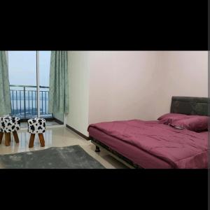 a bedroom with a bed and a large window at 2 BR Jungle Decor Beautiful Sea View Fast Internet Top Of The Mall in Jakarta
