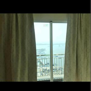 a window with a view of the ocean from a hotel room at 2 BR Jungle Decor Beautiful Sea View Fast Internet Top Of The Mall in Jakarta