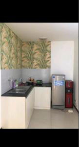 a kitchen with a stainless steel refrigerator in a room at 2 BR Jungle Decor Beautiful Sea View Fast Internet Top Of The Mall in Jakarta