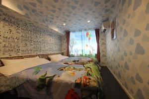 a bedroom with a bed and a window with monsters on it at Chiba sta 1min J hotel 2020 Open in Chiba