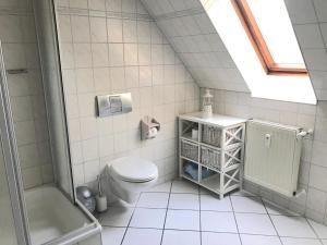 a bathroom with a toilet and a shower at Ferienwohnung Strandperle in Prerow +16 photos
