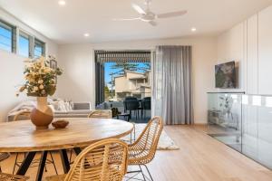 a kitchen and living room with a table and chairs at 22 North - Lennox Head in Lennox Head