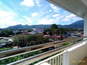 a balcony with a view of a city and mountains at Centtro Residences in Los Baños