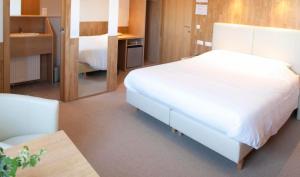 Ένα ή περισσότερα κρεβάτια σε δωμάτιο στο Hotel Chamdor