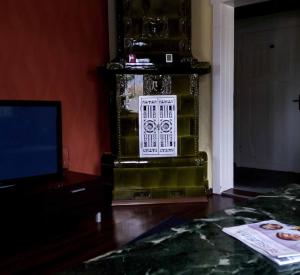 a living room with a television and a fireplace at Ferienwohnung Erzgebirge in Geyer