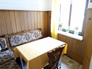 a room with a table and a bench and a window at Ferienwohnung Erzgebirge in Geyer