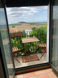 a view of a table and chairs from a window at El Olivo de Sansol in Sansol