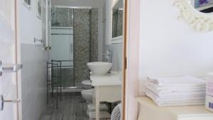 a bathroom with a toilet and a sink and a mirror at Marilyn's House in Frascati