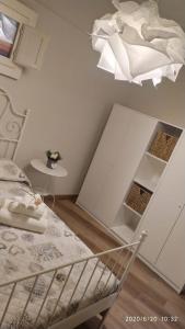 a bedroom with a bed and a chandelier at B&B La Casetta in Castellaneta