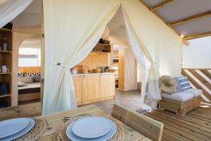 een kamer met een tent met een tafel en stoelen bij Agricampeggio Oasi del Garda in Lazise