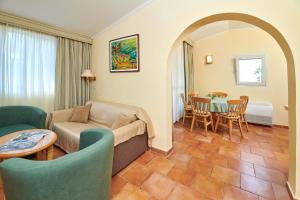 a living room with a couch and a table at Apartments Bellevue Plava Laguna in Poreč