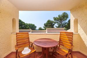 a table and two chairs on a balcony at Apartments Bellevue Plava Laguna in Poreč
