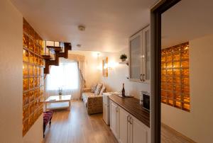 a kitchen and living room with a couch and a table at Glarus Hotel in Murmansk