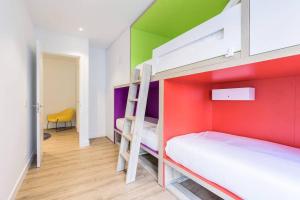 a bedroom with two bunk beds with colorful walls at BUENPAS in San Sebastián