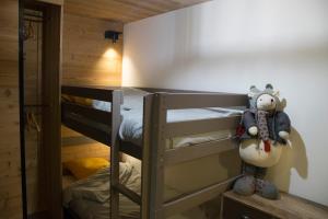 a bedroom with two bunk beds and a teddy bear at Appartement 3 étoiles - au pied des pistes in Valmeinier