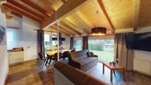 a living room with a couch and a table at Appartement Kitzsteinhorn in Kaprun