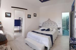a white bedroom with a bed and a doorway at Hill Valley View in Vico Equense