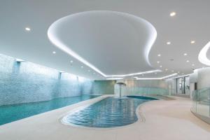a large swimming pool in a large building at The Headland Hotel and Spa in Newquay
