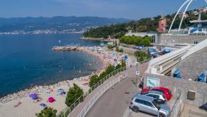 a beach with a lot of people and the water at Apartmani Dada in Rijeka