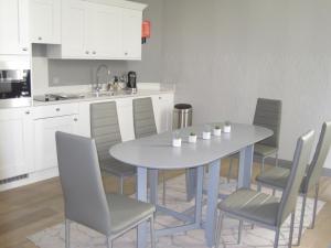 a kitchen with a table and chairs in a kitchen at No.8 Waterloo Street in Birmingham +52 photos