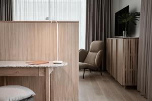 a room with a desk with a chair and a lamp at Original Sokos Hotel Tripla Helsinki in Helsinki