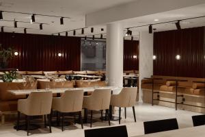 a restaurant with tables and chairs in a room at Original Sokos Hotel Tripla Helsinki in Helsinki