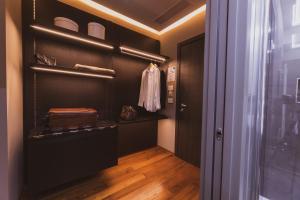 a walk in closet with a black wall at Callistos Hotel & Spa in Tricase
