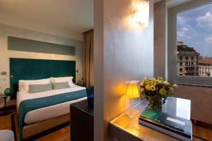 a hotel room with a bed and a window at Bianca Maria Palace Hotel in Milan