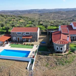 an aerial view of a house with a swimming pool at Casa Dos Xarês in Rosmaninhal