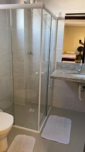 a glass shower in a bathroom with a toilet at Apartamento centro Porto belo!! in Porto Belo +20 photos