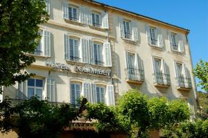 a building with a hotel commerce sign on it at Hôtel Colombet in Nyons